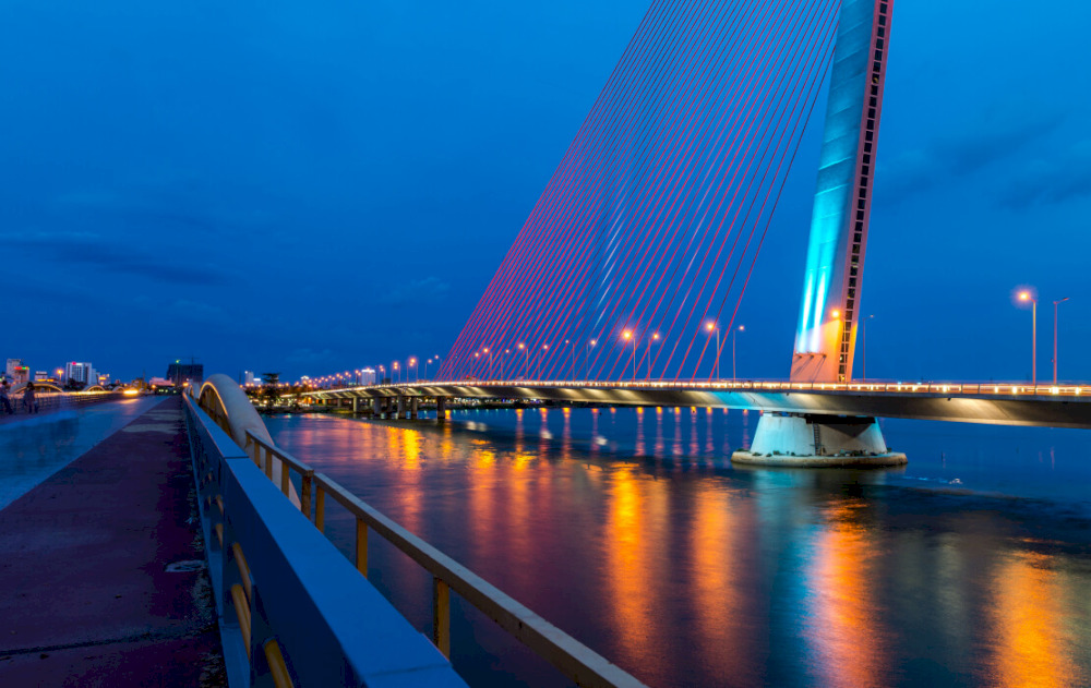 The modern lighting design enhances the beauty of Tran Thi Ly Bridge as night sets in